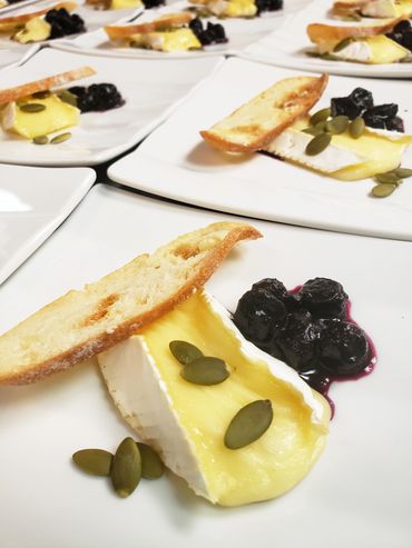 Bake Brie with Toasted Pumpkin Seed, Dried Berries and Crostini catered from Sheraton Parkway