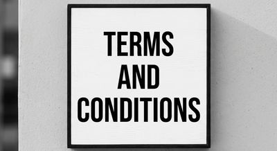 Black and white sign with terms and conditions text.
