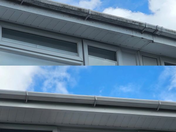 Comparison of a dirty roof gutter and a clean roof gutter under a blue sky.