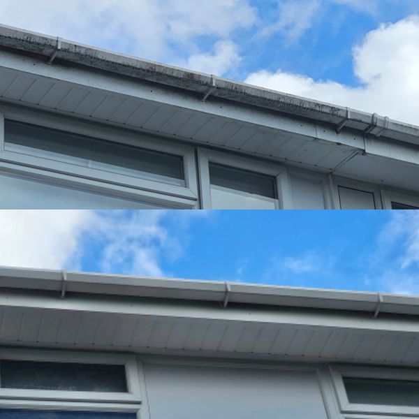 Comparison of a dirty roof gutter and a clean roof gutter under a blue sky.