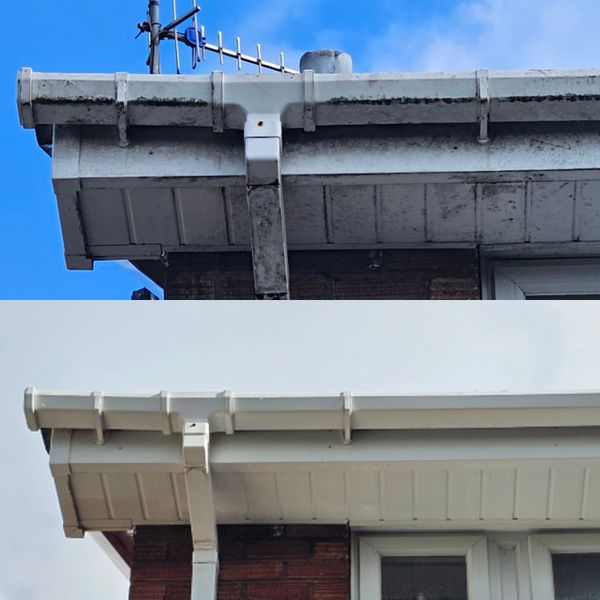 Comparison of a dirty and clean white gutter on a house roof.