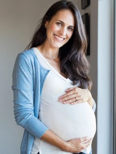 Happy, healthy expecting mother who is smiling