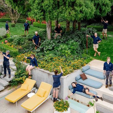 Group photo or gardeners with their tools.