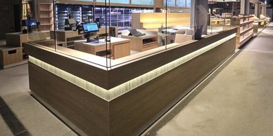 Modern retail checkout counter with clear divider screens.