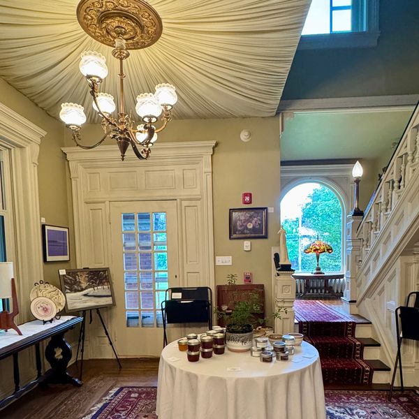 Elegant room with chandelier, round table, and staircase.