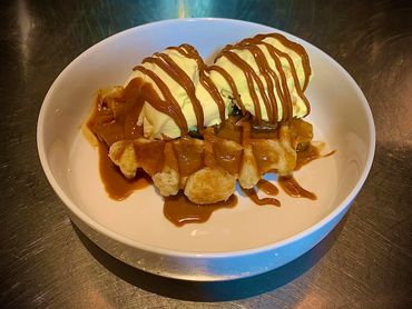 Warm waffle, ice cream and biscoff sauce
