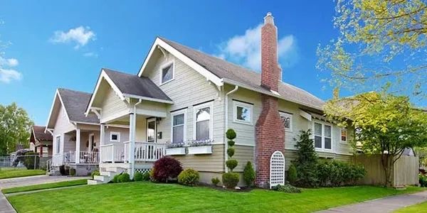 A medium-sized investment property. A House and yard with two houses to its left.