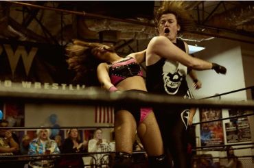 Wrestler delivering a powerful move to opponent in a wrestling ring.