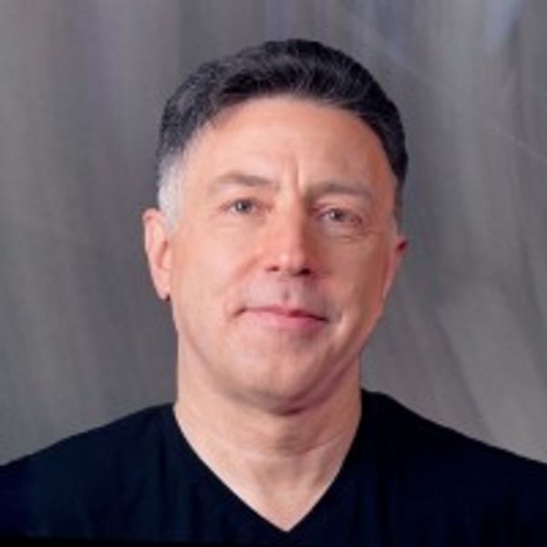 Portrait of a middle-aged man with short dark hair and a slight smile.