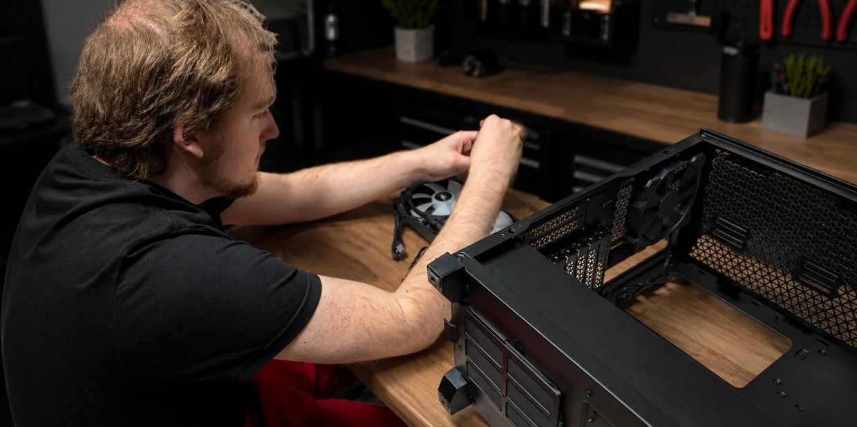 Technician assembling AIO cooler.