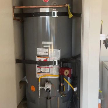 Gray water heater installed in a small closet.