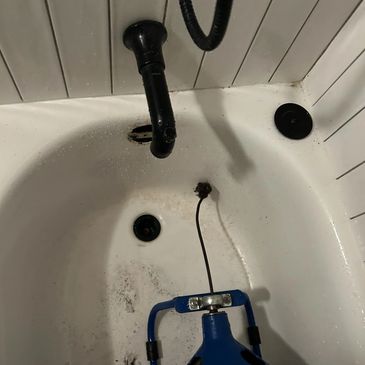 Bathtub with a broken or detached faucet pipe.