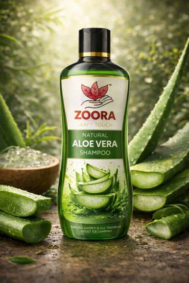 Zoora Natural Aloe Vera Shampoo bottle surrounded by fresh aloe leaves.