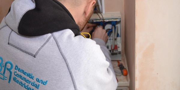 Electrician at work on a consumer unit. 