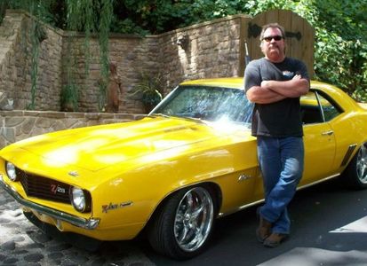 Steve Simpson posed next to his Camaro