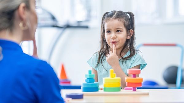 Woman joyfully playing with a young child