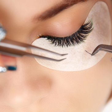 Close-up of eyelash extension being applied.