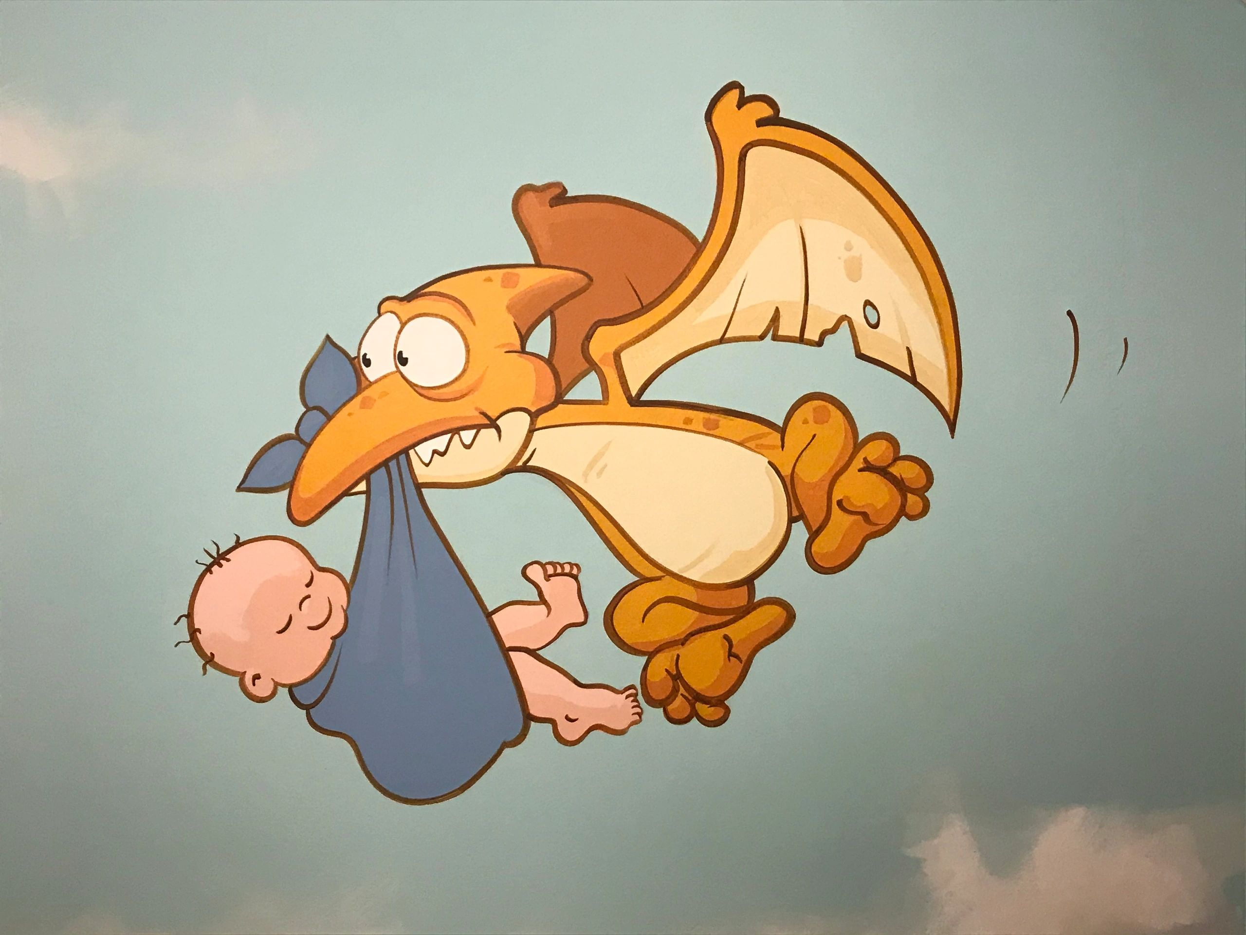 Painted pterodactyl dinosaur mural in a bay's nursery room
