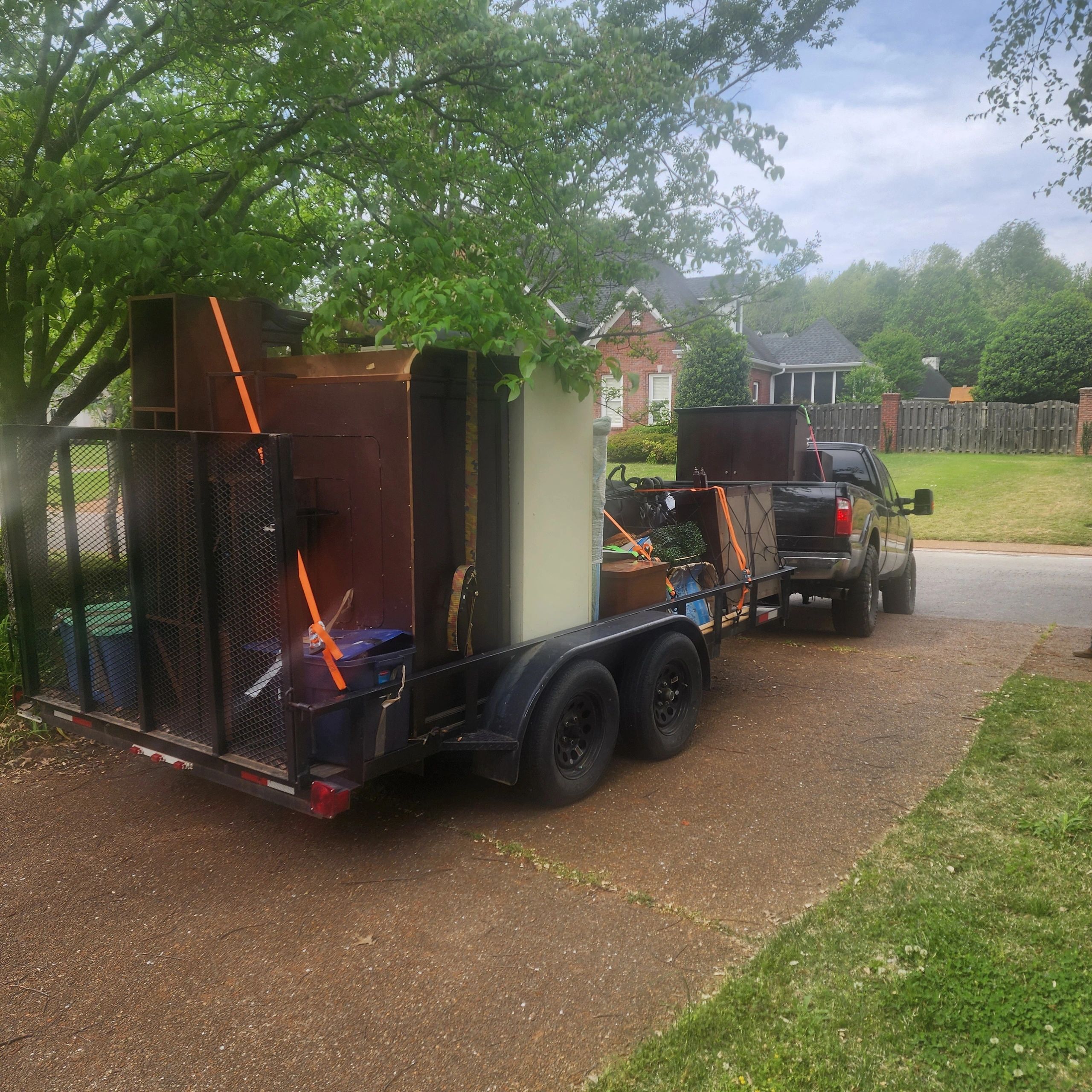 Truck with trailer loaded with furniture and items.