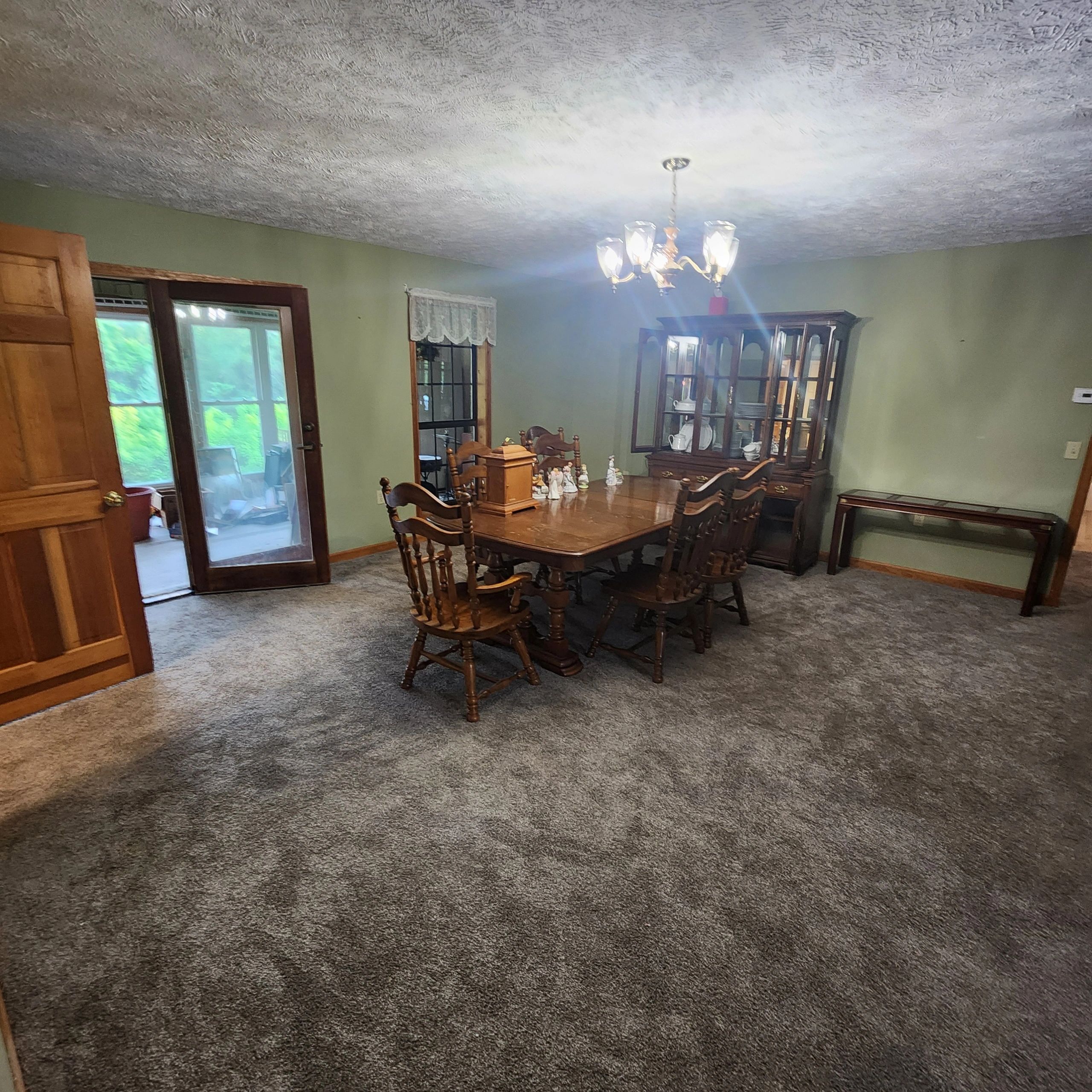 Traditional dining room with wooden furniture and chandelier.