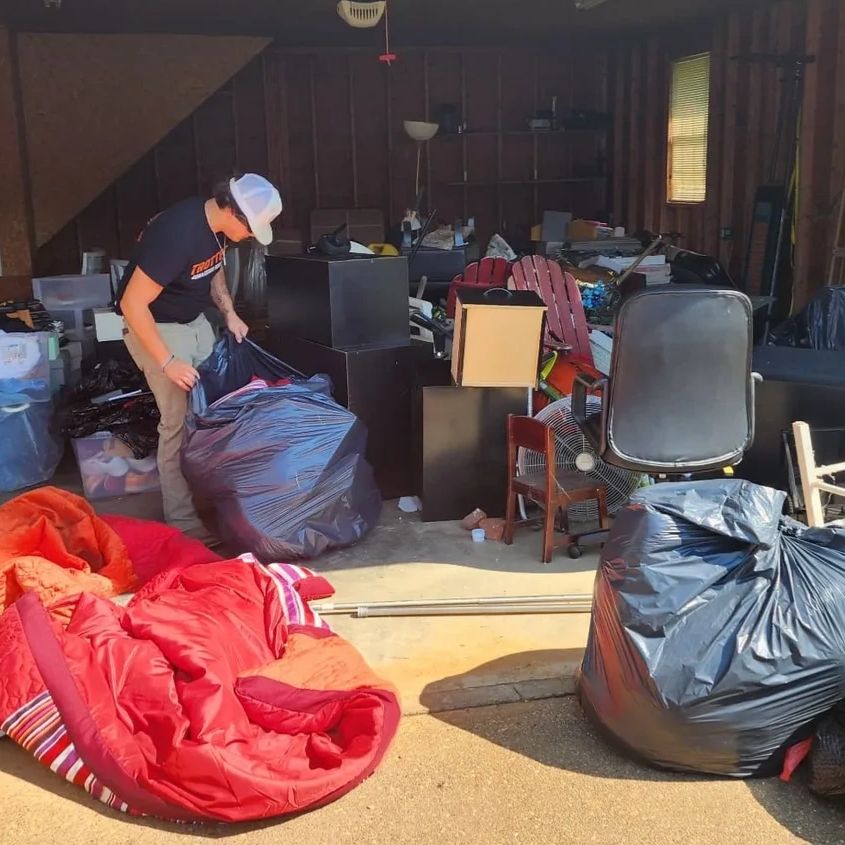 Person cleaning and organizing a cluttered garage.