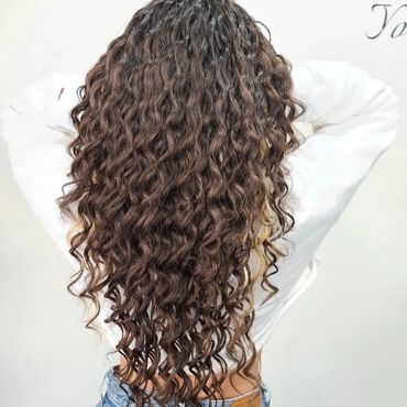 Long curly brown hair shown from the back.