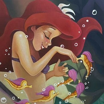 A girl with red hair playing with small colorful sea creatures.
