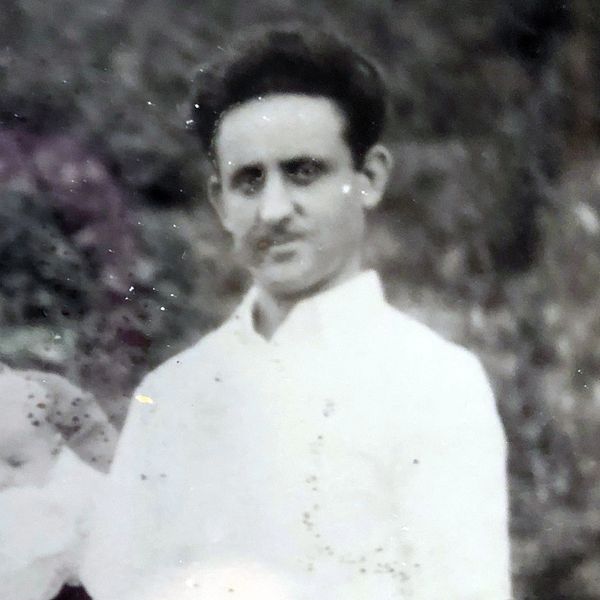 Black and white portrait of a man in a white shirt.