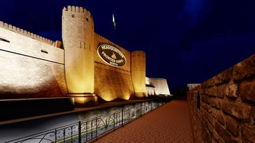 Illuminated fortress at night, showcasing its imposing walls and structures against a dark sky.