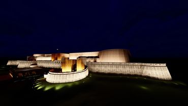 Illuminated fortress at night, showcasing its imposing walls and structures against a dark sky.