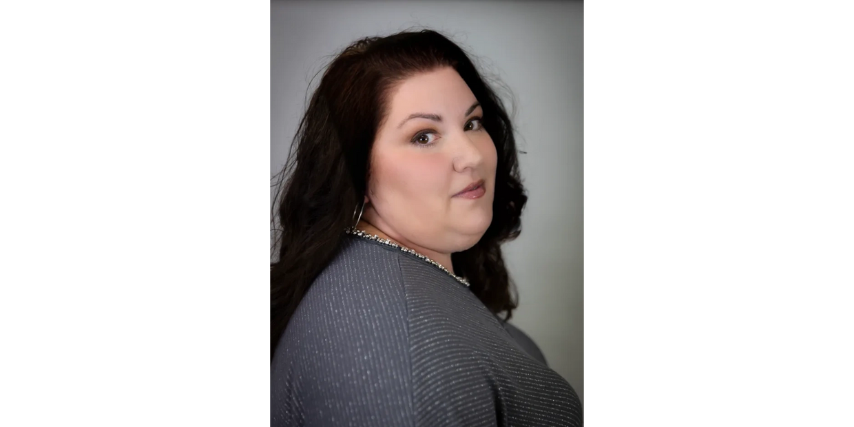 Portrait of a woman with dark hair and a subtle smile.