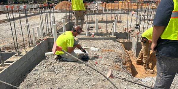Construction workers working on a foundation site.