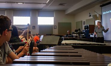 Students learning the story of the drum set from historian Kelli Rae Tubbs www.kellieraetubbs.com