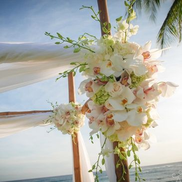 bamboo wedding arch with flowers white and pink orchids ocean view ceremony 