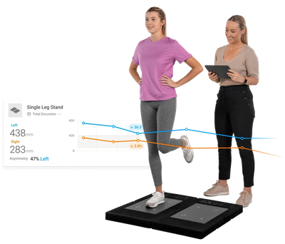 Woman balancing on one leg while another person monitors data.