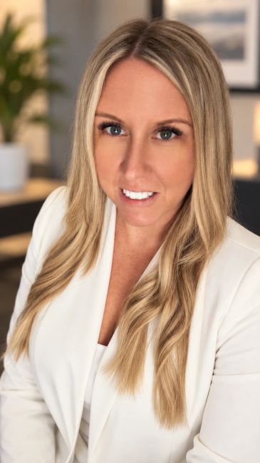 Professional woman with long blonde hair in white blazer.