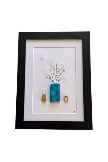 Framed mixed media art with sea glass and drawn flowers.