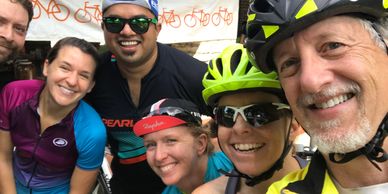 Six cyclists smiling at the camera.