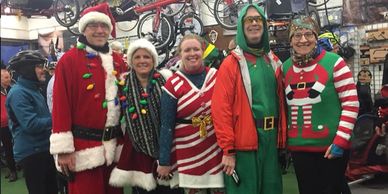 Five cyclists wearing Christmas costumes. 