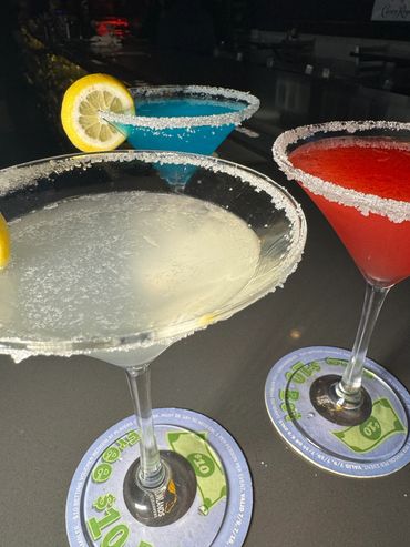Colorful cocktails served in martini glasses