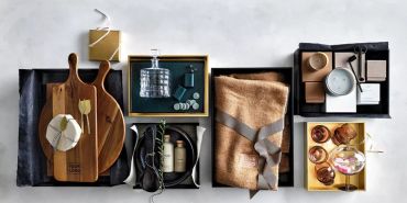Elegant gift boxes with kitchenware and personal care items.