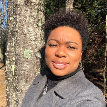a woman in grey coat clicking a selfie