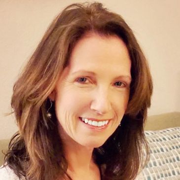 Brown hair, blue eyed headshot of Melissa Gomer - owner