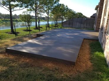 A new concrete patio, at least 6 inches thick, serves as a solid foundation for outdoor living.