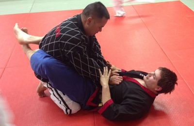 Grappling techniques from Judo being demonstrated to Dean Corbin. 