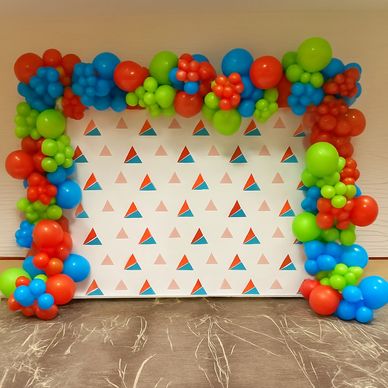 Organic garland arch over step and repeat signage for a corporate event in Birmingham AL