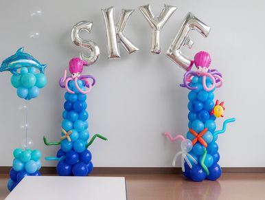 Foil letter arch with themed Under the Sea balloon columns for birthday party decor in Homewood AL