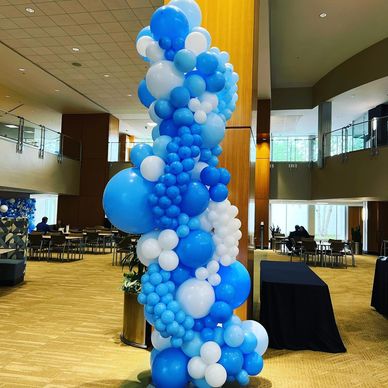 Blue and white balloon column with mini garlands at indoor corporate event in Birmingham AL.