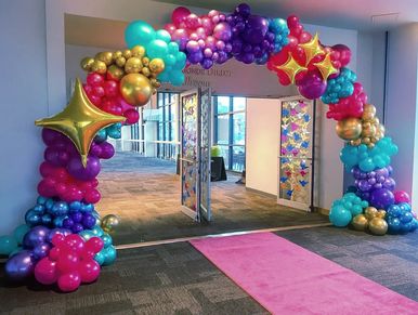 Deluxe balloon arch with star point accents for prom school dance in Birmingham AL.