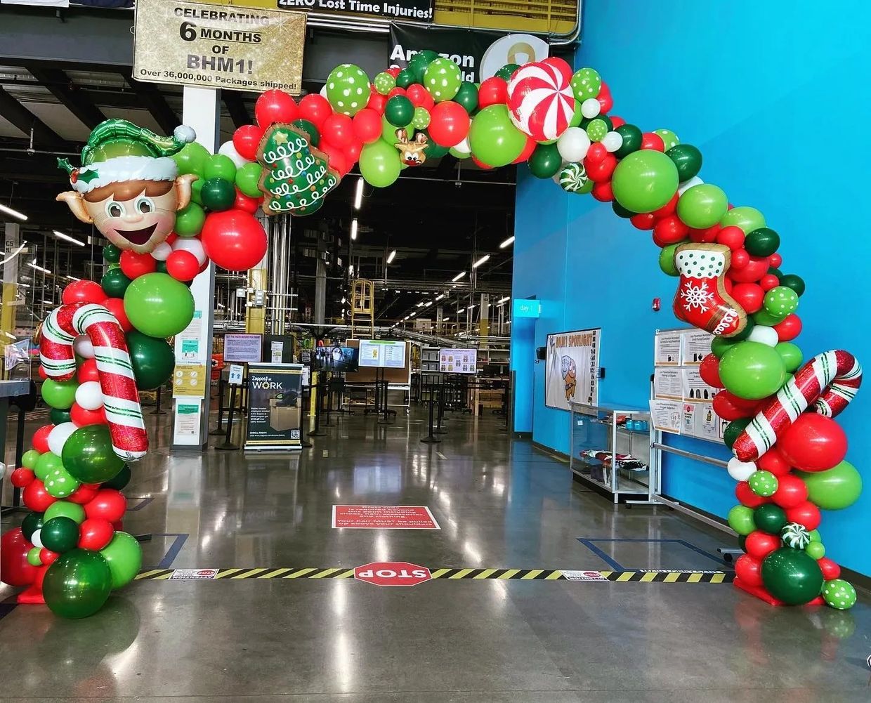 Christmas theemd balloon arch wtih candy cane and Elf balloon accents.